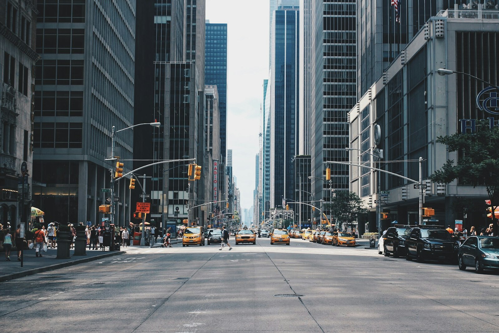 A crowded city street lined with billboards and traffic